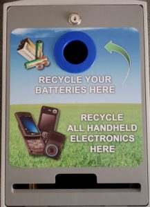 The lid of the Tech Double has two openings: one round for batteries; one narrow rectangular for handhelds. The rectangular opening is wide enough for a tablet. The top locks down to prevent pilfering or tampering with the contents.